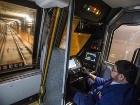 TTC subway operator Gus Tzirivilas sits at the controls of subway train on auto-pilot heading southbound between Yorkdale and Dupont Stations in Toronto, Ont., on Friday, Nov. 3, 2017. Even though the train is controlled by a computer, the operator has to keep him hands on the controller at all times.
