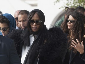 Naomi Campbell, center, and former fashion models Afef Jnifen, right, and Farida Khelfa, left, attend the funeral ceremony of Tunisian-born designer Azzedine Alaia in Sidi Bou Said, north of the Tunisian capital Tunis, Monday, Nov. 20, 2017. Azzedine Alaia, an iconoclast whose clingy dresses marked the 1980s and who dressed famous women from Hollywood to the White House, has died at age 77. (AP Photo/Amine Landoulsi)