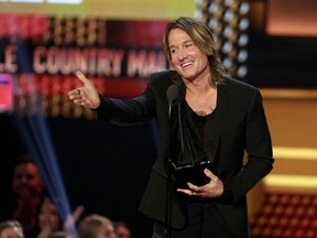 Keith Urban accepts the award for favourite male artist country, favourite song country for "Blue Ain't Your Color" and favourite album country for "Ripcord" at the American Music Awards at the Microsoft Theater on Sunday, Nov. 19, 2017, in Los Angeles. (Matt Sayles/Invision/AP)