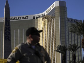 In this Tuesday, Oct. 3, 2017 file photo, a Las Vegas police officer stands by a blocked off area near the Mandalay Bay casino in Las Vegas.