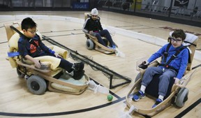 Hockey players( L to R) Liam Marriage, Bharjeet Sandhu and Ryan Kugler using sleds during a Volt hockey team practice at Variety Village on Saturday, Nov. 25, 2017.