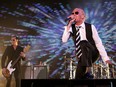 In this May 17, 2008, file photo, Scott Weiland, the late singer for the rock band Stone Temple Pilots, right, and bass player Robert DeLeo perform during their concert as part of Rock on the Range in Columbus, Ohio. (AP Photo/Paul Vernon, File)