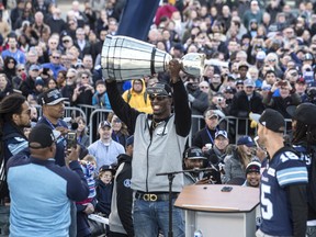 Argonauts running back James Wilder Jr. holds the Grey Cup during a rally at Nathan Phillips Square on Tuesday. (THE CANADIAN PRESS)