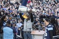 Argonauts running back James Wilder Jr. holds the Grey Cup during a rally at Nathan Phillips Square on Tuesday. (THE CANADIAN PRESS)