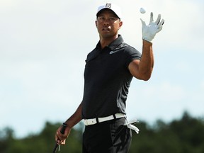 Tiger Woods catches a ball as he warms up on the range for the first round of the Hero World Challenge at Albany, Bahamas, on Nov. 30, 2017
