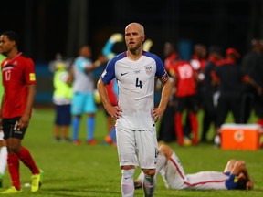 A contrast of emotions as captain Michael Bradley (C) of the United States mens national team reacts as Trinidad and Tobago pull of a win during the FIFA World Cup Qualifier match between Trinidad and Tobago at the Ato Boldon Stadium on October 10, 2017 in Couva, Trinidad And Tobago. (Photo by Ashley Allen/Getty Images)