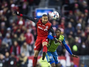 Toronto FC's Justin Morrow wins a header against Seattle Sounders' Kelvin Leerdam during Saturday's MLS Cup final. (ERNEST DOROSZUK/Toronto Sun)