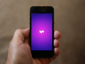 A smartphone displays the Lyft app. (AP Photo/Paul Sancya)