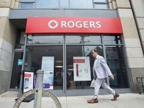 TORONTO, ONTARIO: Wednesday, July 19, 2017 -  A man walks past a Rogers store on Queen Street East in Toronto, ON on Wednesday July 19, 2017.
