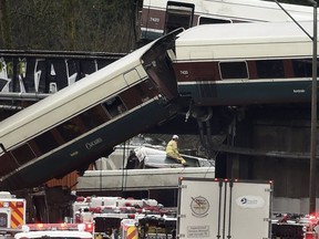 Cars from an Amtrak train that derailed above lie spilled onto Interstate 5 alongside smashed vehicles on Dec. 18, 2017, in DuPont, Wash.