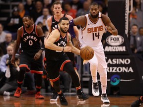 Raptors point guard Fred VanVleet moves the ball upcourt ahead of Suns forwad Greg Monroe during last night’s game in Phoenix at Talking Stick Resort Arena. (GETTY IMAGES)