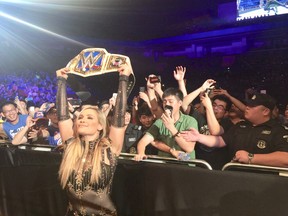 Natalya Neidhart holds up her SmackDown Women’s Championship during a WWE show in Shanghai earlier this year. (SUPPLIED PHOTO)
