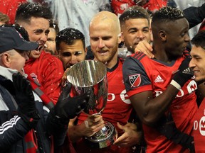 TORONTO, ON - NOVEMBER 29:  Michael Bradley #4 of Toronto FC looks at the MLS Eastern Conference Finals trophy following victory in the 2nd leg against Columbus Crew SC at BMO Field on November 29, 2017 in Toronto, Ontario, Canada.  (Photo by Vaughn Ridley/Getty Images)