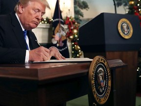 U.S. President Donald Trump signs a proclaimation that the U.S. government will formally recognize Jerusalem as the capital of Israel after signing the document in the Diplomatic Reception Room at the White House Dec. 6, 2017 in Washington, D.C. (Chip Somodevilla/Getty Images)