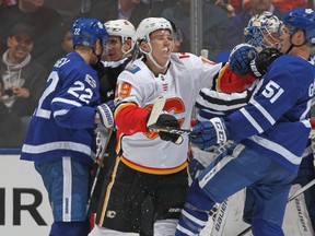 Matthew Tkachuk #19 of the Calgary Flames battles against Jake Gardiner #51 of the Toronto Maple Leafs during an NHL game at the Air Canada Centre on December 6, 2017 in Toronto, Ontario, Canada. (Photo by Claus Andersen/Getty Images)