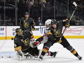 Marc-Andre Fleury #29 of the Vegas Golden Knights blocks a shot as Lars Eller #20 of the Washington Capitals and Jon Merrill #15 of the Golden Knights battle in front of the net during the third period of their game at T-Mobile Arena on December 23, 2017 in Las Vegas, Nevada. The Golden Knights won 3-0.