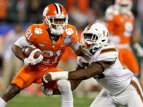 Ray-Ray McCloud of the Clemson Tigers runs the ball against Zach McCloud of the Miami Hurricanes during the ACC Championship at Bank of America Stadium on December 2, 2017 in Charlotte, North Carolina.