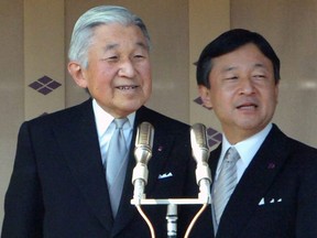 Japan's Emperor Akihito (L) and Crown Prince Naruhito (R) appear on the balcony at the Imperial Palace in Tokyo to greet well-wishers on November 21, 2012. KAZUHIRO NOGI/AFP/Getty Images