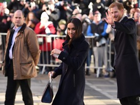 Britain’s Prince Harry’s fiancee and US actress Meghan Markle gesture on leaving an engagement at Nottingham Contemporary in Nottingham, central England, on December 1, 2017. OLI SCARFF/AFP/Getty Images