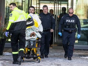 Paramedics with a person on a stretcher following a violent incident that left a baby in critical condition at a condo building at Sherway Gardens Rd. and Evans Ave. on Wednesday, December 13, 2017.