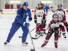 Maple Leafs head coach Mike Babcock skates with the kids during a practice with the Don Mills Mustangs at the MasterCard Centre on Monday. (Ernest Doroszuk/Toronto Sun)