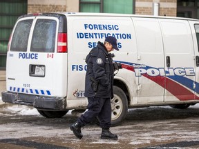 Forensic police outside of a condo building where a violent incident left a baby in critical condition at Sherway Gardens Rd. and Evans Ave. on Wednesday December 13, 2017.