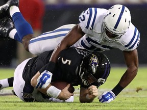 Quarterback Joe Flacco #5 of the Baltimore Ravens is sacked by outside linebacker Barkevious Mingo #52 of the Indianapolis Colts in the second quarter at M&T Bank Stadium on December 23, 2017 in Baltimore, Maryland. (Photo by Patrick Smith/Getty Images)