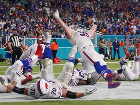 Buffalo Bills defensive tackle Kyle Williams and a group of players fall to the ground in celebration after Williams scored a touchdown, during the second half of an NFL football game against the Miami Dolphins, Sunday, Dec. 31, 2017, in Miami Gardens, Fla. (AP Photo/Wilfredo Lee)
