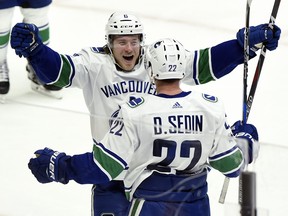 Vancouver Canucks left wing Daniel Sedin (22), of Sweden, celebrates with right wing Brock Boeser (6) after Sedin scored against the Nashville Predators on Nov. 30, 2017, in Nashville, Tenn. Sedin recorded his 1,000th career NHL point on the play. (MARK ZALESKI/AP)