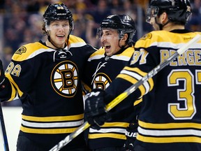 Boston Bruins linemates David Pastrnak, Brad Marchand and Patrice Bergeron