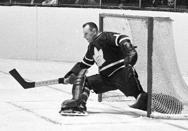 Toronto Maple Leafs' Johnny Bower makes a kick save during a playoff action against the Montreal Canadiens in Montreal in 1966. Canadian hockey legend Johnny Bower has died. A statement from his family says the 93-year-old died after a short battle with pneumonia. THE CANADIAN PRESS ORG XMIT: CPT123