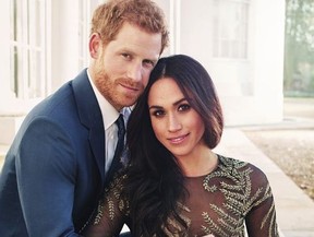 In this image released by Kensington Palace on Thursday, Dec. 21, 2017, Britain’s Prince Harry and Meghan Markle pose for one of two official engagement photos, at Frogmore House, in Windsor, England.