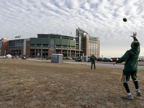 Fans play catch outside Lambeau Field before an NFL football game between the Green Bay Packers and the Tampa Bay Buccaneers Sunday, Dec. 3, 2017, in Green Bay, Wis.