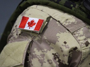 A Canadian flag patch is shown on a soldier's shoulder in Trenton, Ont., on Oct. 16, 2014. (Lars Hagberg/The Canadian Press/Files)