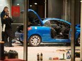 Police officers inspect damage in the lobby of the German Social Democratic Party (SPD) headquarters after a car was used to ram the building in Berlin early Dec. 25, 2017. (ODD ANDERSEN/AFP/Getty Images)