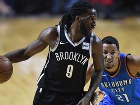 Oklahoma City Thunder Andre Roberson  vies for the ball with Brooklyn Nets DeMarre Carroll on Dec. 7, 2017