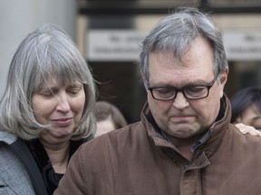 Clayton Babcock, right, stands next to his wife Linda as he reads a prepared statement outside court in Toronto on Saturday, December 16, 2017. Two men accused of killing a young Toronto woman and burning her body have been found guilty of first-degree murder. Dellen Millard and Mark Smich had pleaded not guilty to the charges related to the death of 23-year-old Laura Babcock, whose body has not been found.