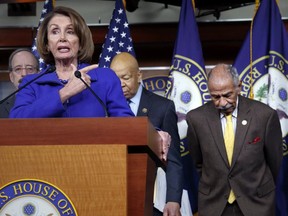 In this file photo from Feb. 14, 2017, House Minority Leader Nancy Pelosi, D-Calif., Rep. John Conyers, D-Mich., right, and other top House Democrats, appear at a news conference on Capitol Hill in Washington.