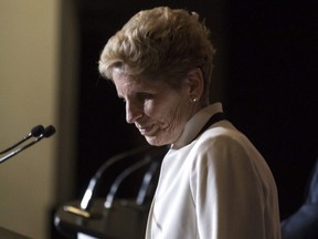 Ontario Premier Kathleen Wynne turns away from the podium after speaks with journalists alongside Quebec Premier Phillippe Couillard after they attended the Confederation of Tomorrow 2.0 Conference in Toronto on Tuesday December 12, 2017.