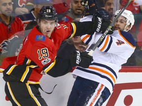 The Flames' Matthew Tkachuk mixes it up with Edmonton defenceman Kris Russell on Dec. 2, 2017.