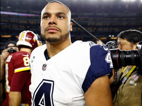 Dak Prescott of the Dallas Cowboys walks off the field after the 38-14 win over the Washington Redskins at AT&T Stadium on November 30, 2017 in Arlington, Texas. (Wesley Hitt/Getty Images)