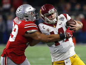 Malik Harrison of the Ohio State Buckeyes runs Sam Darnold of the USC Trojans out of bounds in the Cotton Bowl December 29, 2017 in Arlington, Texas.