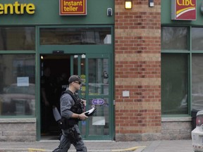 Peel Regional Police scour the Bovaird Dr. and Conestoga Dr. area in Brampton for two men in an alleged bank robbery Tuesday morning.