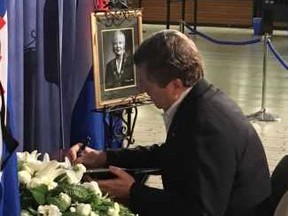 Toronto Mayor John Tory signs the books of condolence for trailblazer June Rowlands.