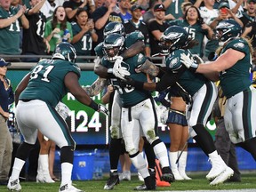 Linebacker Chris Long #56 of the Philadelphia Eagles is mobbed by his teammates after stripping the ball from Jared Goff #16 of the Los Angeles Rams at Los Angeles Memorial Coliseum on December 10, 2017 in Los Angeles, California. The Eagles recovered the fumble. (Kevork Djansezian/Getty Images)