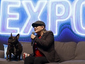 Carrie Fisher speaks on stage with her dog Gary during the Edmonton Comic & Entertainment Expo at the Edmonton Expo Centre in Edmonton, Alberta on Saturday, September 24, 2016. Ian Kucerak / Postmedia