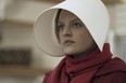 This image released by Hulu shows Elisabeth Moss as Offred in a scene from, "The Handmaid's Tale."  (George Kraychyk/Hulu via AP)