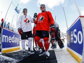 Canada's Dante Fabbro, right, and Boris Katchouk, walk off the ice following their outdoor hockey practice at New Era Field on Dec. 28, 2017