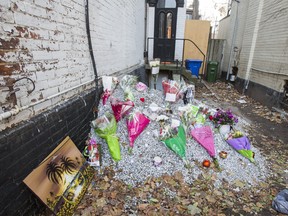 Outside of the abandoned building where the body of homicide victim Tess Richey was found, her memory is honoured by cards, candles, flowers and memorabilia near the corner of Church St. and Wellesley St. E. in Toronto, Ont.  on Sunday December 3, 2017. Ernest Doroszuk/Toronto Sun/Postmedia Network