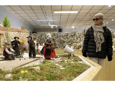 A woman looks at a crib in the village of Aubagne, near Marseille, southern France, Thursday, Nov. 30, 2017.